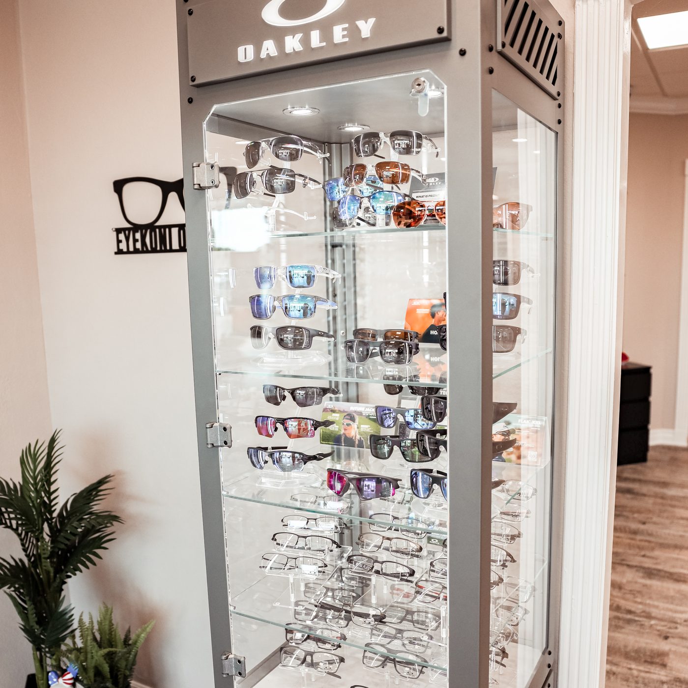 Oakley signature display case at Eye Koni Optical featuring performance frames and sunglasses