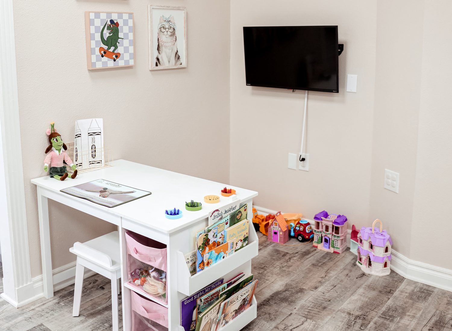 Eye Koni Optical's kids' corner — framed art, a small craft table, picture books, and toys